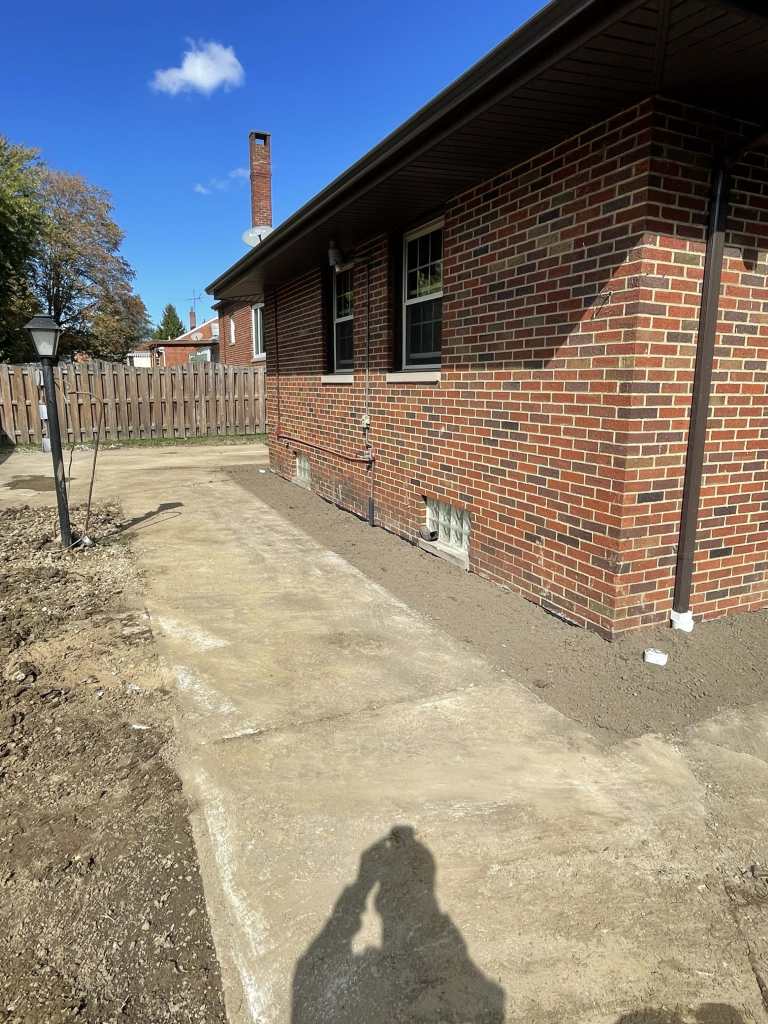 Brick house with concrete pathway outdoors
