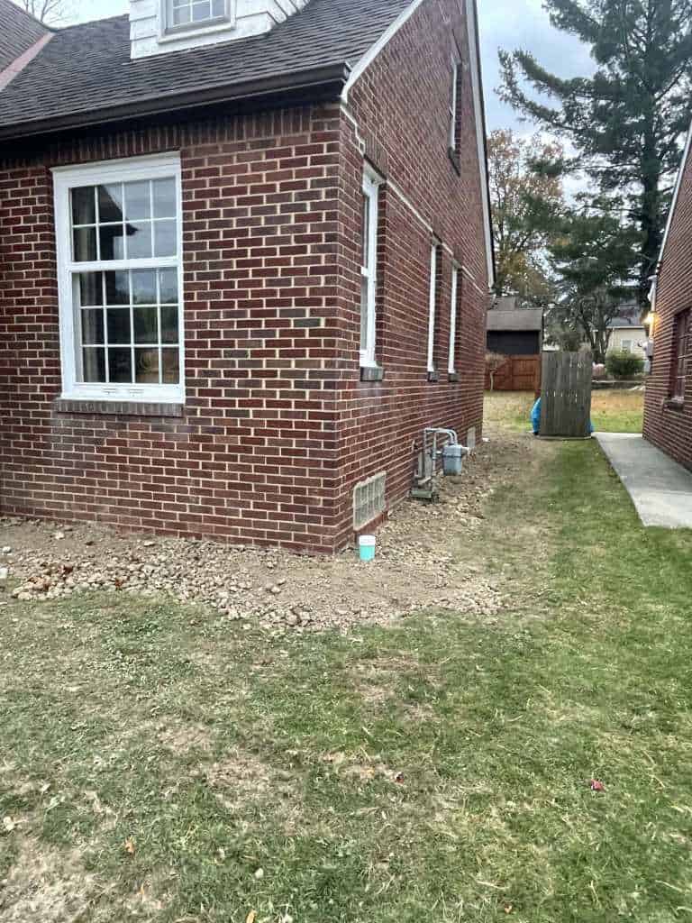 Brick house corner with grassy area