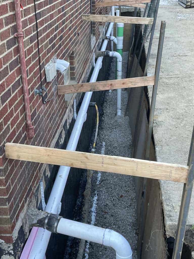 Excavated area with drainage pipes installed