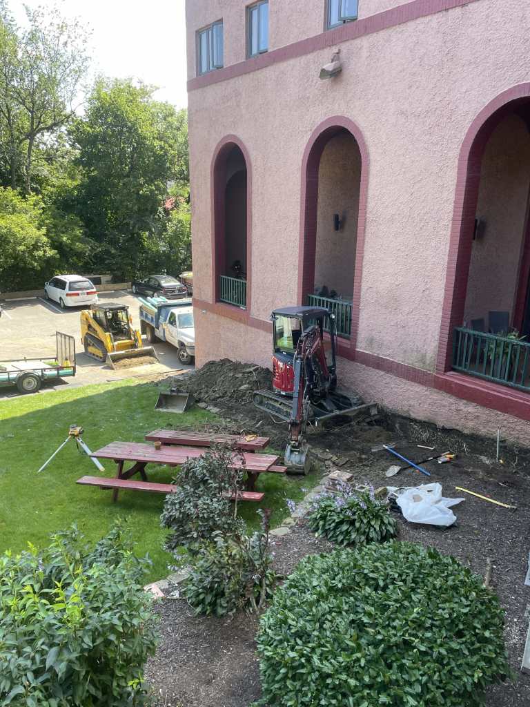 Excavation work near building entrance.