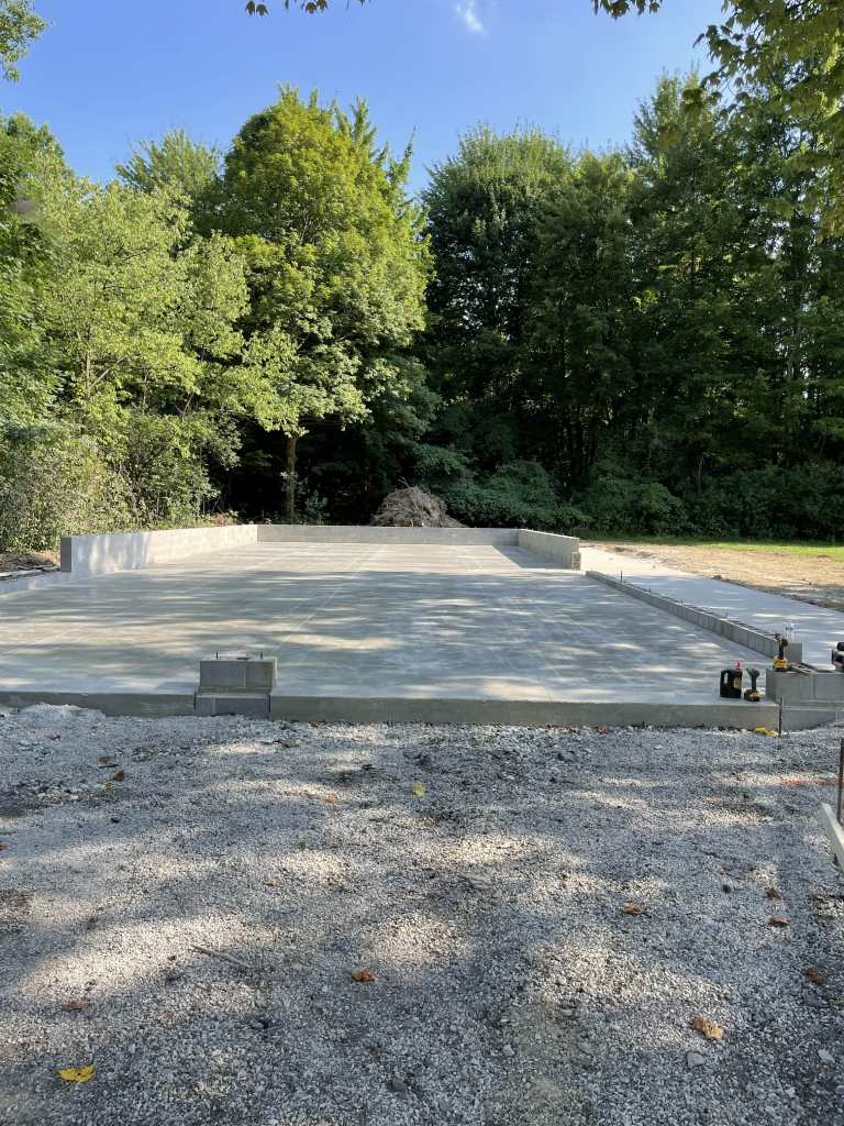 Concrete foundation in wooded area