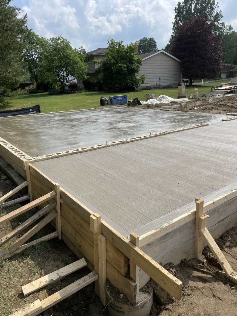 Freshly poured concrete foundation slab