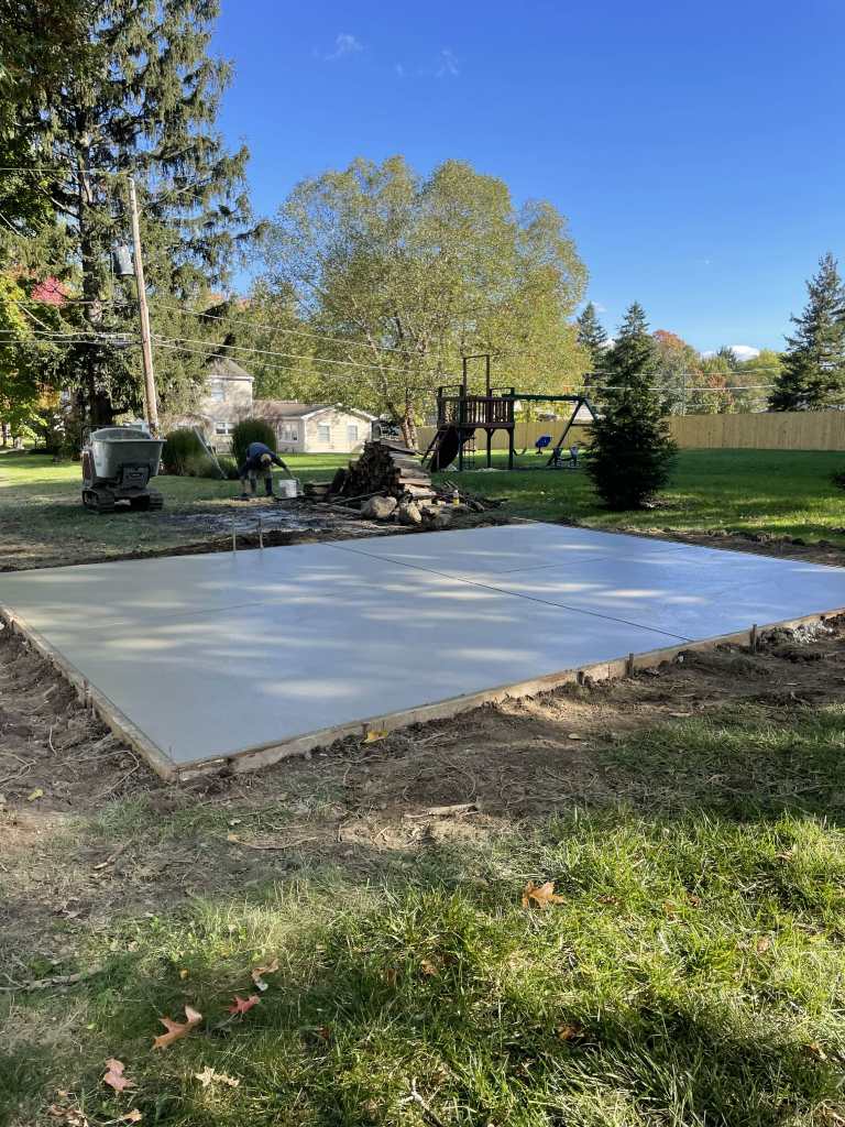 Freshly poured concrete slab in yard