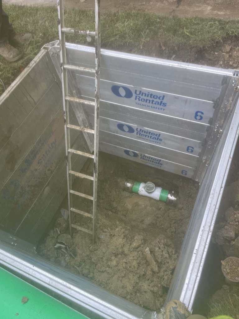Excavation site with ladder and equipment
