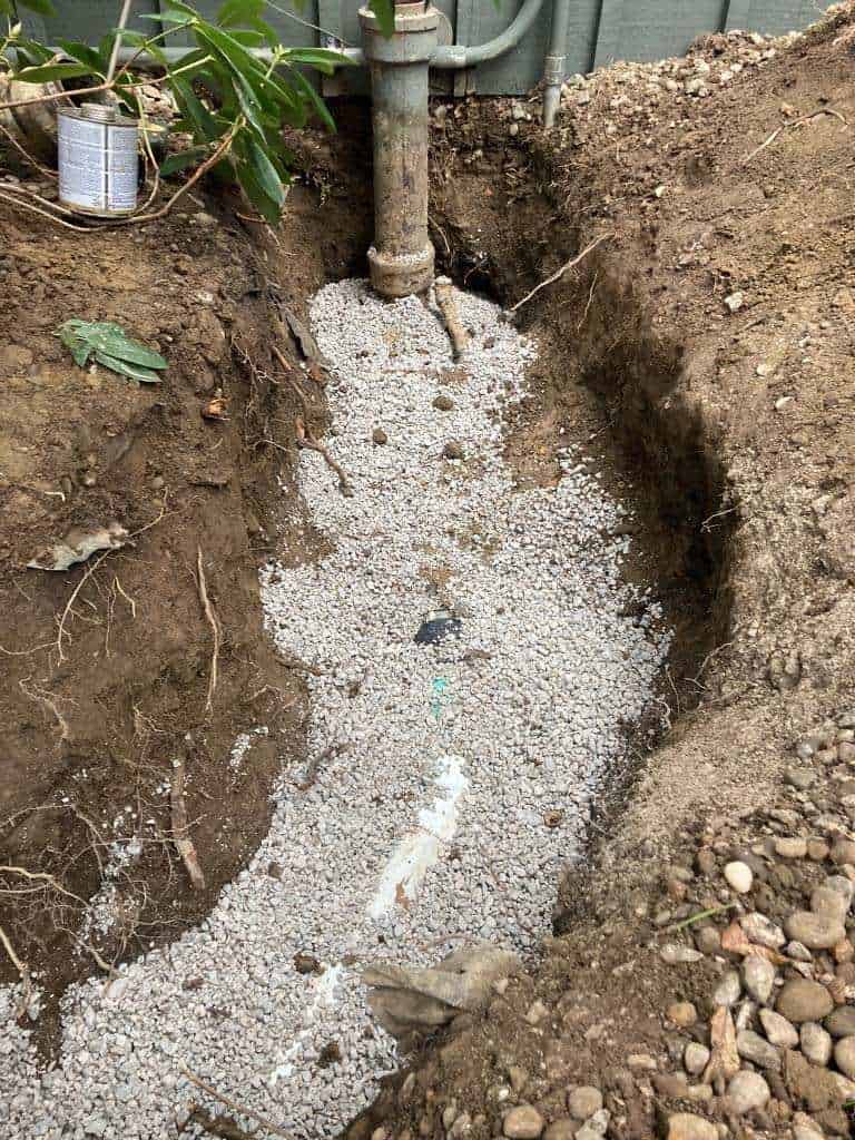 Excavated trench with gravel and pipe