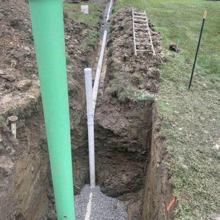 Excavated trench with sewer pipes installed