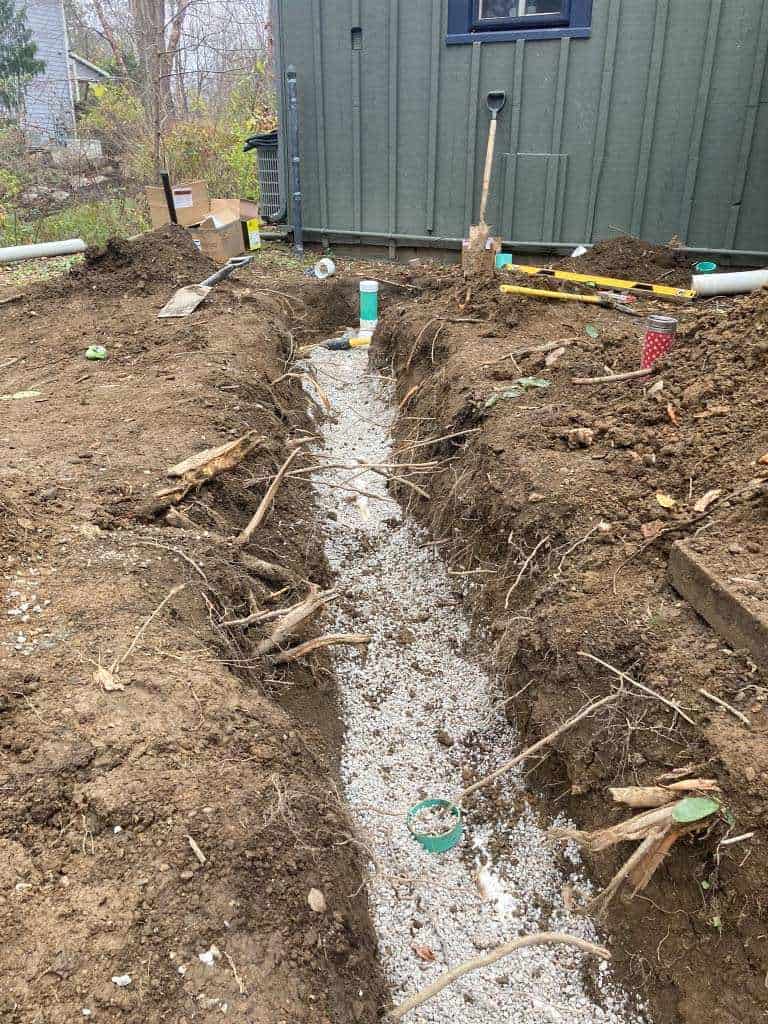 Excavated trench for sewer installation.