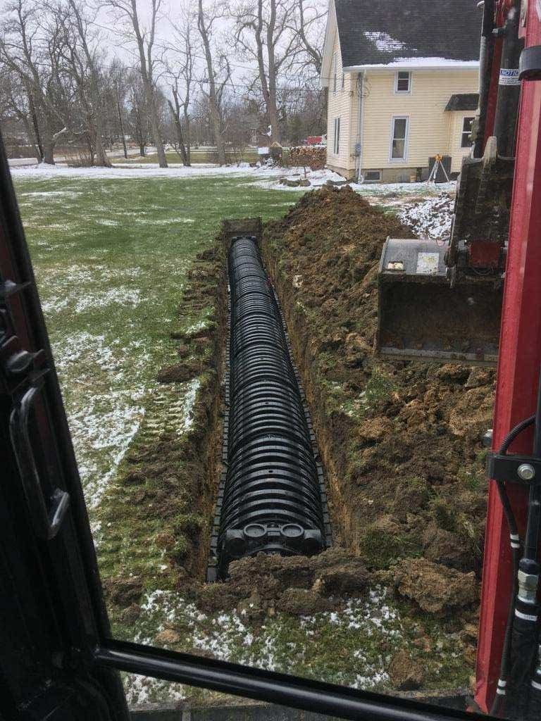 Excavated trench for sewer installation.