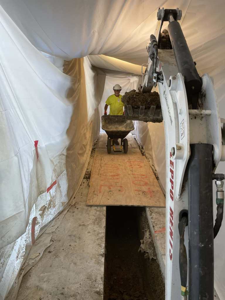 Construction worker in underground tunnel.