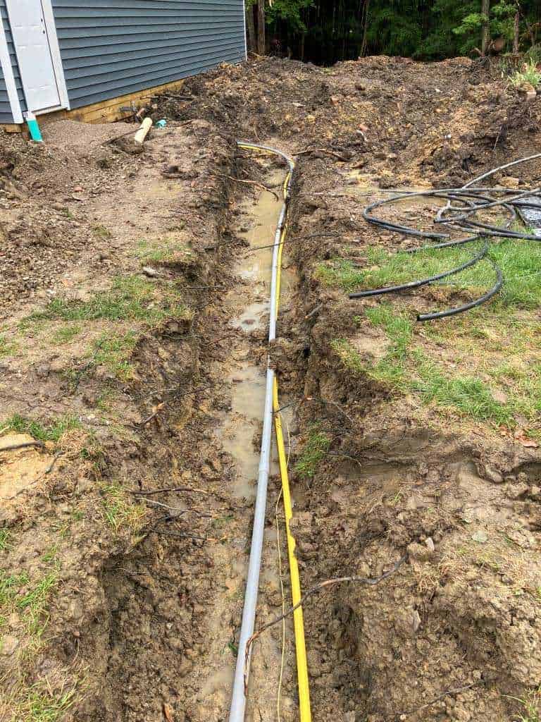 Trench with utility pipes and mud