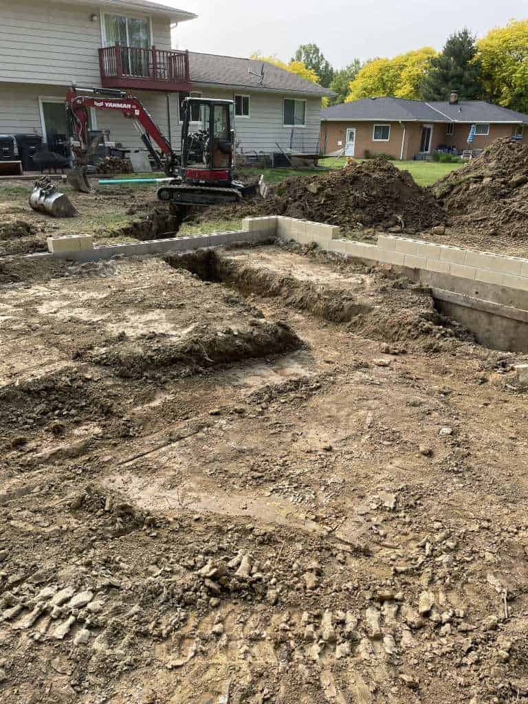 Excavation site with machinery and foundation