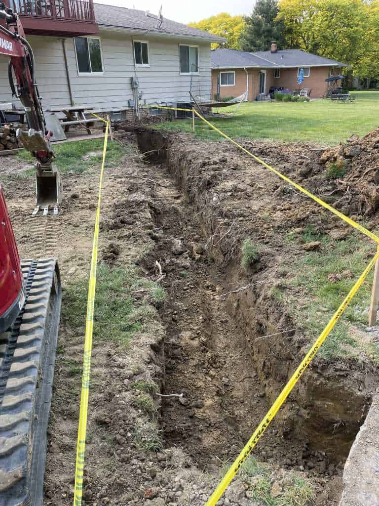 Excavated trench in residential yard