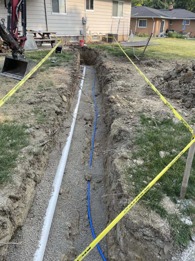 Trench with pipes and safety markings