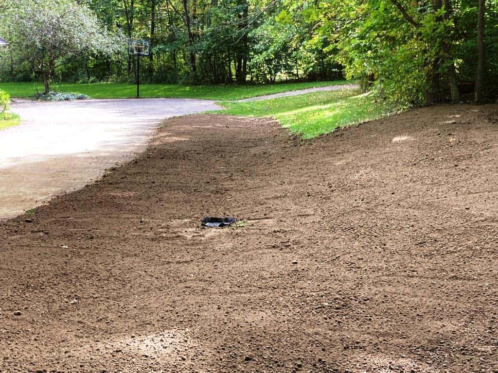 Cleared area with drainage system visible